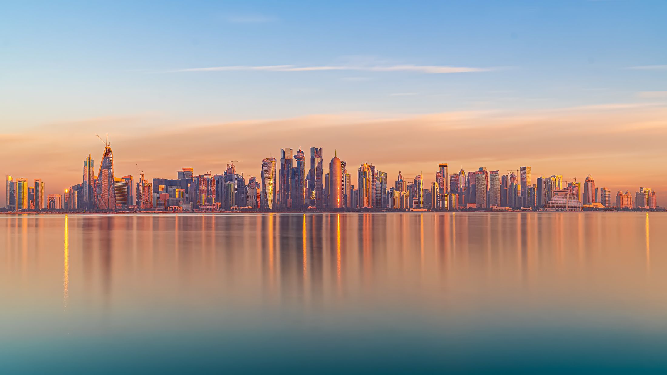 Doha’s West Bay skyline across the water at sunset